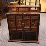 CHINESE DOWRY CHEST with carved panels depicting warrior/fighting scenes and floral carvings above