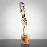 AFRICAN IVORY CARVING OF A STANDING MALE FIGURE modelled with long earlobes, 32cm high