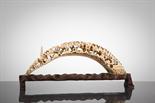 CHINESE IVORY BRIDGE CARVING depicting scholars in a landscape setting, on wooden stand, 28cm long
