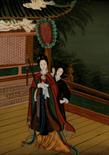CHINESE PAINTING ON GLASS depicting two females in an architectural setting, framed 60cm x 43.5cm