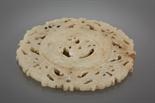 CHINESE JADE BI DISC of pierced circular form, with mythical creature decoration, 12cm diameter