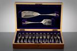 EDWARDIAN SILVER PLATED CANTEEN OF FISH KNIVES AND FORKS with floral engraving, in a mahogany case