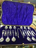 SET OF TWELVE SILVER BRIGHTCUT ENGRAVED PIERCED TEASPOONS AND TONGS the bowls with engraved