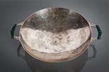 ARTS AND CRAFTS REVIVAL HAMMERED SILVER DISH of circular form and with pierced composite handles,