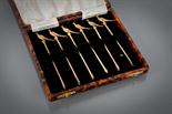 SET OF SIX SILVER GILT COCKTAIL STICKS with terminals modelled in the shape of a pheasant, maker