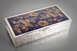 EASTERN SILVER AND ENAMEL CIGARETTE BOX with basket weave style exterior, the lid with chrysanthemum