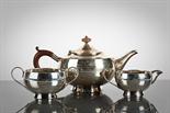 GEORGE V SILVER THREE PIECE TEA SERVICE comprising a teapot, sugar and cream, each of circular