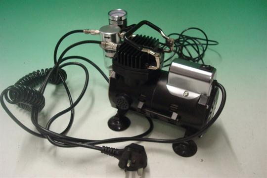 Iwata Compressor and Airbrush: Airbrush model Revolution CR together with Sprint Jet Compressor