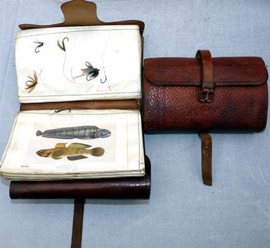ACCESSORIES: An early leather fly wallet with original strap/buckle, 6”x4” overall, parchment page