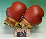 Rare pair of fight worn Henry Cooper boxing gloves signed by Cooper and Ali – comprising a red and
