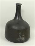 An 18th century green glass mallet shaped wine bottle, 19cm high.