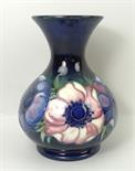 A Moorcroft pottery vase of baluster form decorated in the 'Anenome' pattern against a cobalt blue