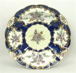A Worcester, First Period, fluted dish reserve decorated with panels of flowers against a blue scale