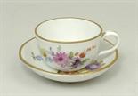 A Meissen porcelain miniature tea cup and saucer, early 20th century, painted with floral sprays,
