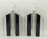 A pair of Art Deco style clear and black glass five section scent bottles, the stoppers with scent