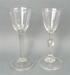 A George III wine glass, the tapering bowl above a knopped stem with tear drop inclusion, raised