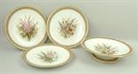 A part Royal Worcester porcelain part dessert service, circa 1875, painted with hollyhocks and