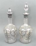 A pair of cut glass decanters and stoppers, late 19th century, with silver resist foliate and