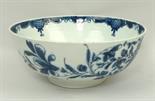A Caughley porcelain bowl, late 18th century, painted in blue and white with flowers, crescent mark,