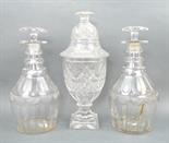 A Regency cut glass urn and cover with hob nail cut finial, raised on a stepped square base, 30cm