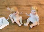 Two bisque porcelain piano babies.