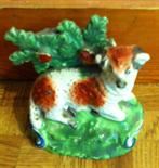 Early Staffordshire figure, sheep on a bank.