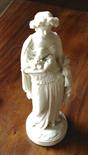 Parian figure, a lady with fruit, slight a/f 33cms.