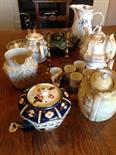 Box lot of china including 5 teapots. Brass candlesticks etc.