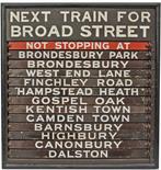 Wooden Destination Board with 13 chocolate & cream enamel indicators. The top is painted `Next Train