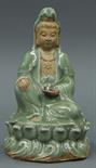 Chinese Longquan-style ceramic Guanyin, seated in royal ease on a celadon glazed lotus pedestal in
