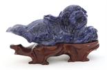 Chinese sodalite fu-lion, in a recumbent position and playing with a ball, with wood stand, 5.5""w