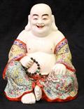 Chinese enameled porcelain Budai, seated in royal ease holding prayer beads and a sack, wearing a
