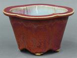 Chinese flambe glazed porcelain planter, 19th century, the tapering lobed body coated with a dark