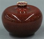Chinese ox blood glaze porcelain brush coupe, Qing dynasty, of apple form with a small flared rim