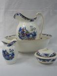 A wash stand set of ewer and basin vase, soap dish etc decorated in polychrome willow pattern on