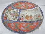 A very large late 19thC Imari charger decorated with chrysanthemums, costumes figures and dragons,