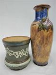 A Doulton Stoneware vase with floral motifs and a Doulton Stoneware jar with relief decoration.