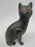 A Bretby pottery figure of a cat with glass eyes.