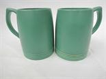 A pair of Keith Murray (1892-1981) designed green Wedgwood tankards. 5".