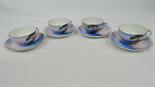 Four noritake cabinet cups and saucers decorated with coastal scenes.