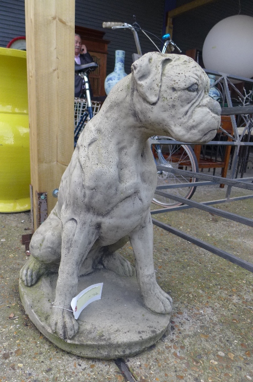 A reconstituted stone statue of a boxer dog