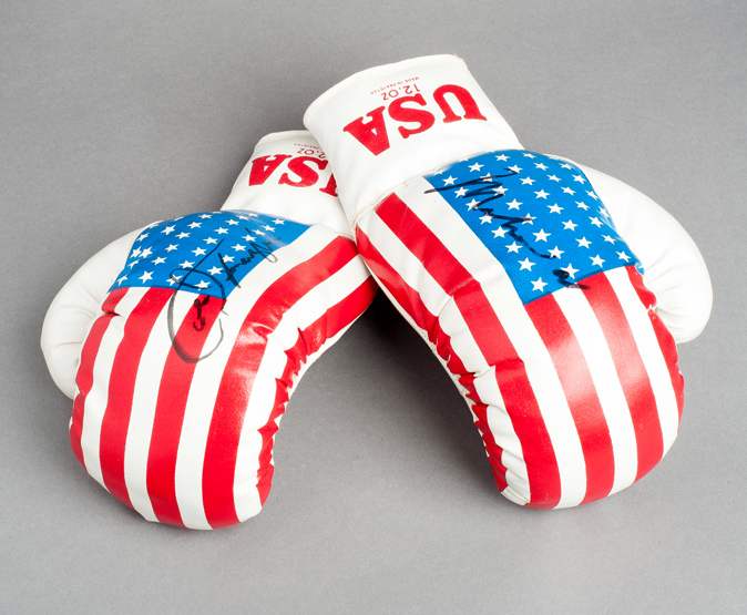 A pair of `stars and stripes` boxing gloves signed by Muhammad Ali and Joe Frazier, Ali has signed
