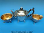 A hallmarked silver three-piece tea set comprising teapot, sugar bowl and milk jug  with gilt