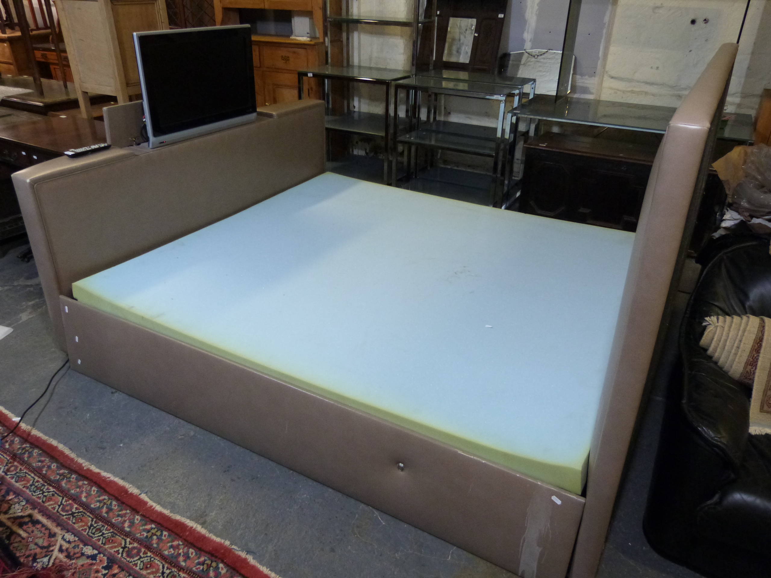 A Super King Size Taupe Leather Bed With Retractable Phillips Tv