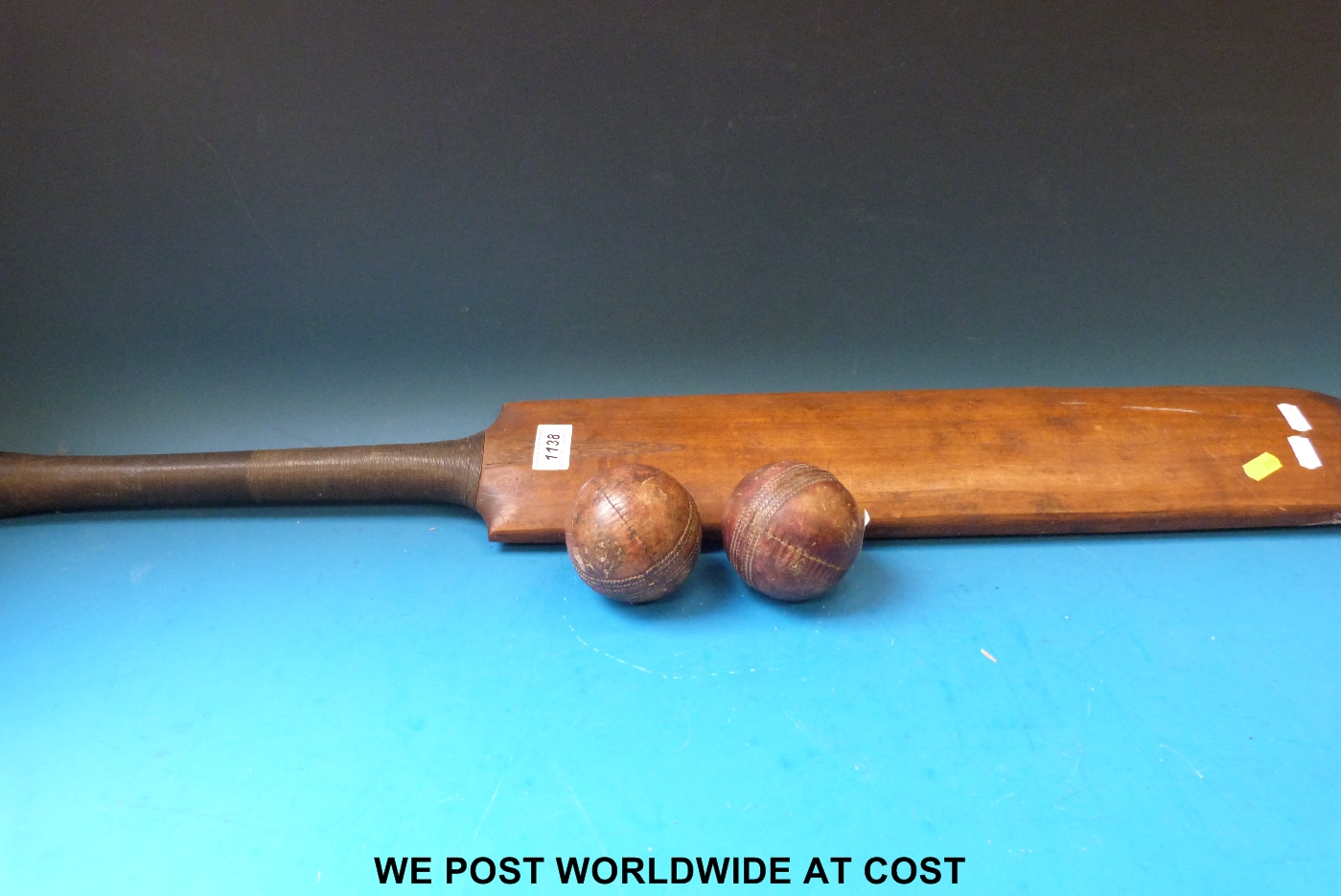 A late 19th / early 20thC cricket bat and two balls