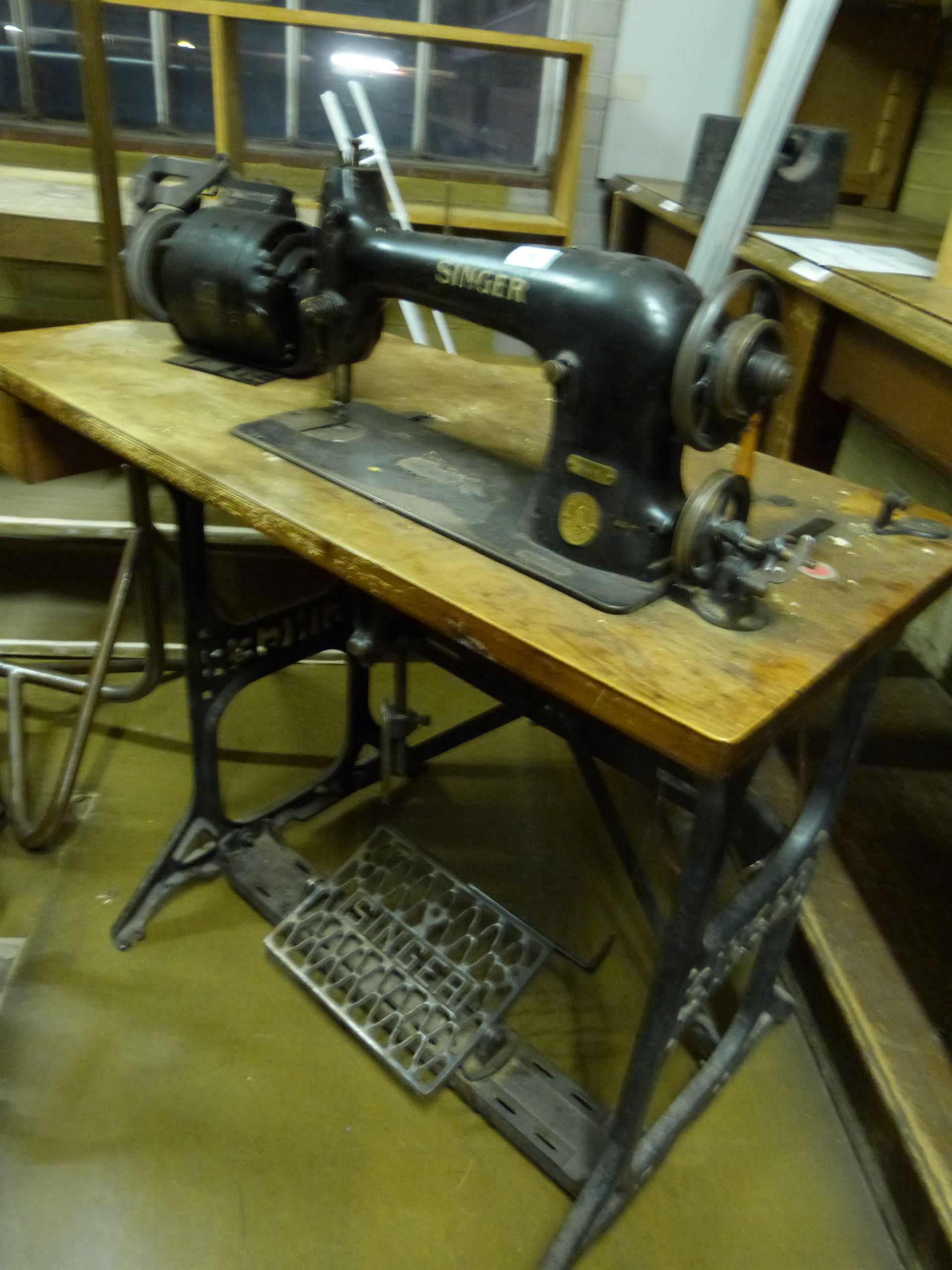 A singer 31K15 industrial sewing machine on base, together with two motors, not in use at time of