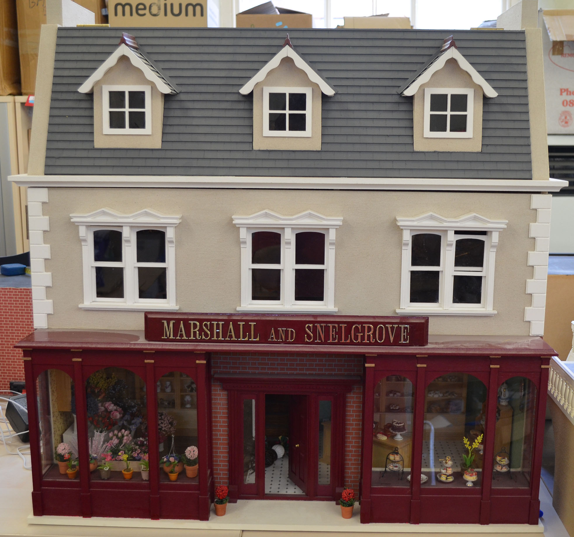 `Marshall and Snelgrove`, three storey doll`s house with hinged front