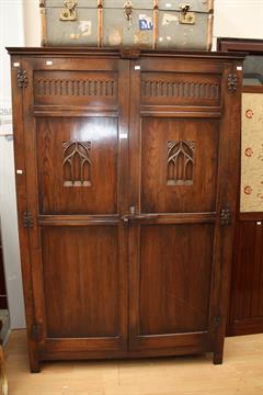 A Large Tudor Style Oak Wardrobe Fitted With Two Doors