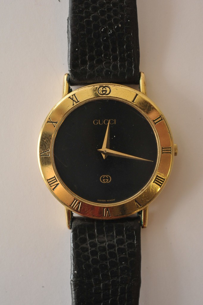 A gold plated Gucci 3000M wristwatch having black dial and black