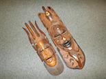 Two wooden carved tribal masks with inlaid detail